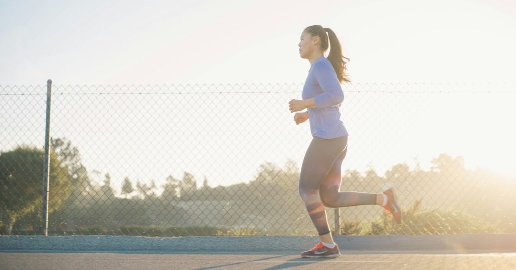 Woman jogging at sunrise